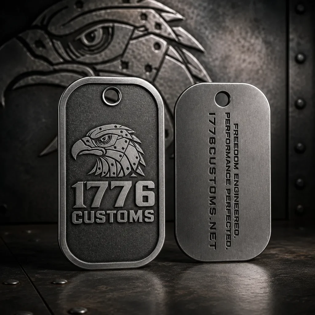 Front and back view of a brushed metal 1776 Customs dog tag key chain featuring an embossed eagle logo.
