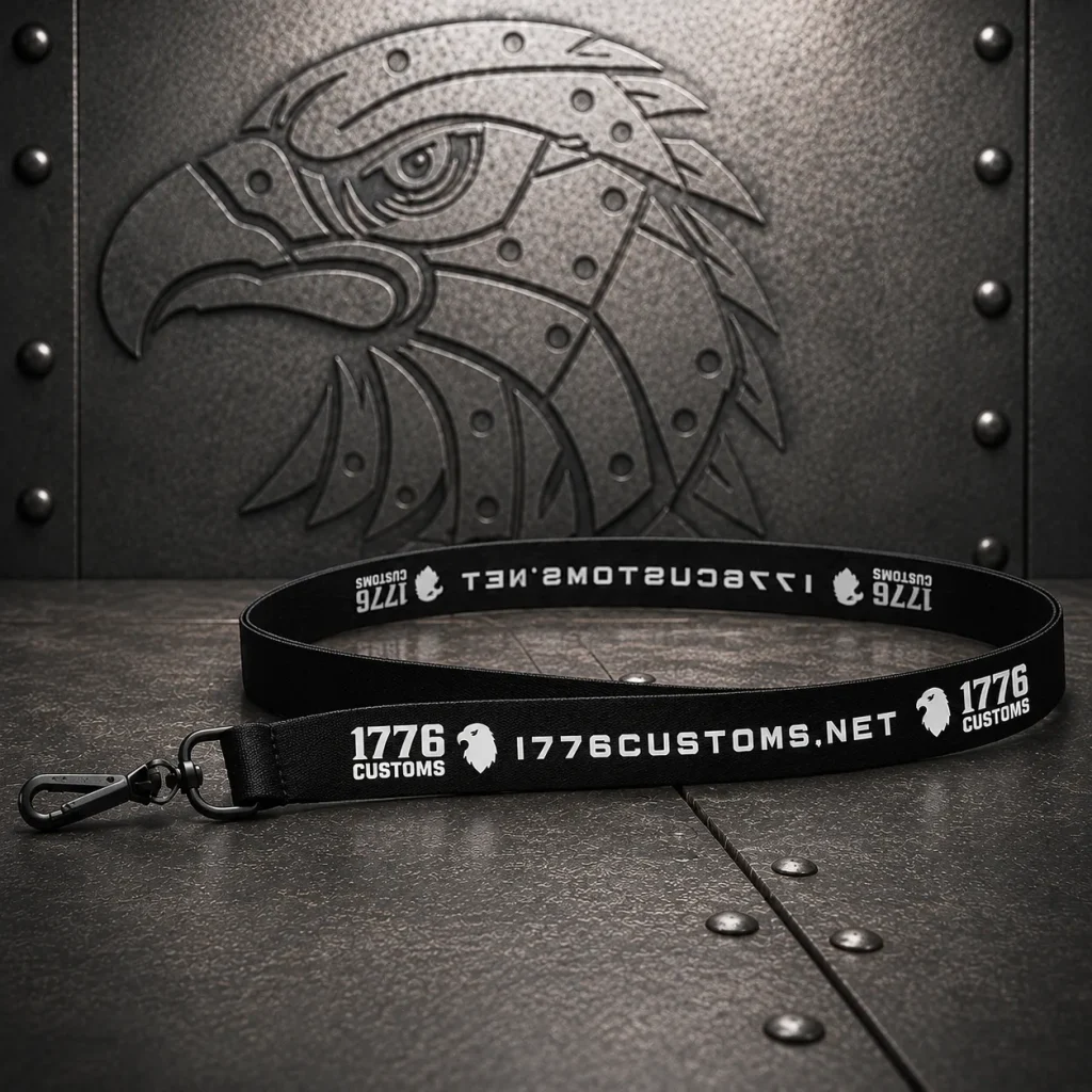Black 1776 Customs key lanyard with white branding and a metal lobster claw clip on a riveted metal background.
