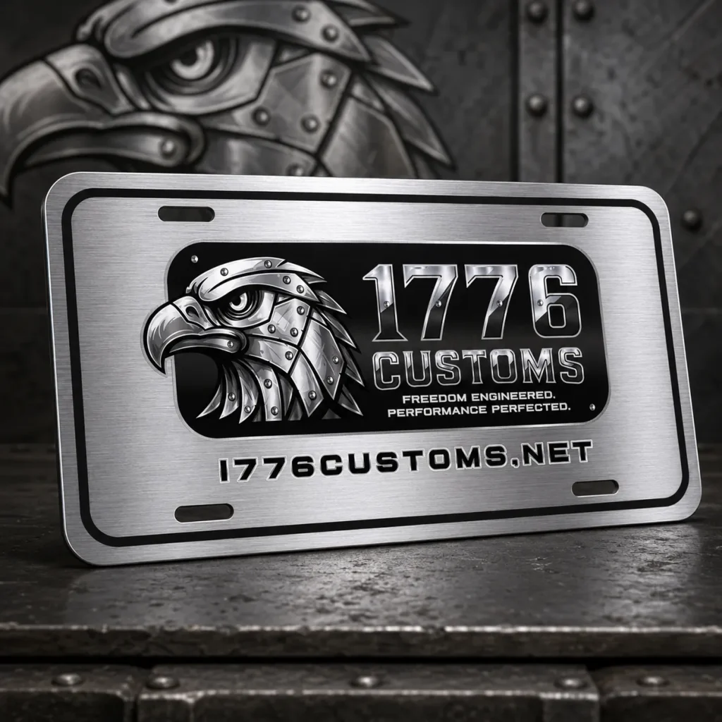 Brushed aluminum 1776 Customs front license plate with a central eagle emblem on a dark metal table.